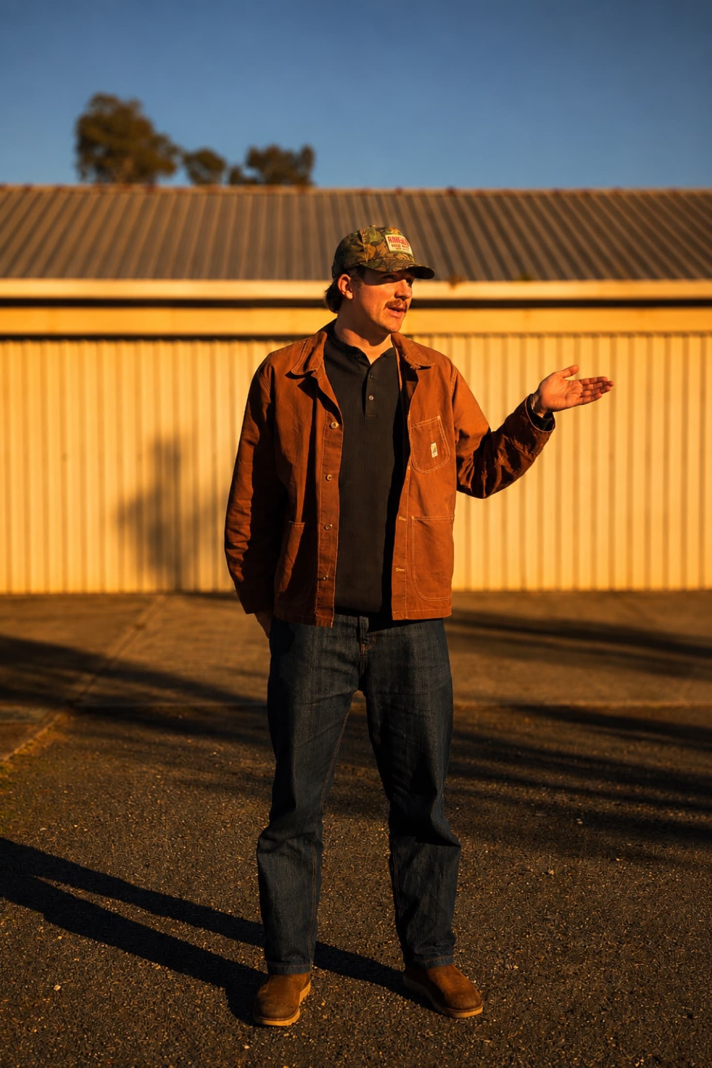 Kai Rennie by a shed at golden hour