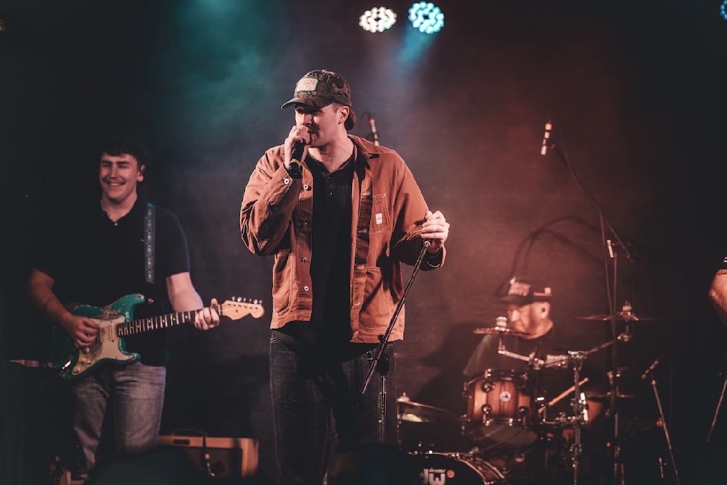 Kai Rennie and his band playing live on stage